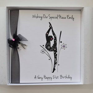 May include: A white card with black text and a black silhouette of a gymnast. The text reads "Wishing Our Special Niece Emily A Very Happy 21st Birthday".