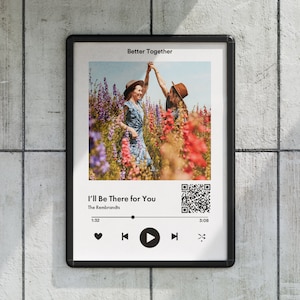 Puede incluir: Una maqueta de reproductor de música digital enmarcada con una foto de dos personas en un campo de flores. El reproductor de música muestra la canción "I'll Be There for You" de The Rembrandts, con un botón de reproducción y un código QR.