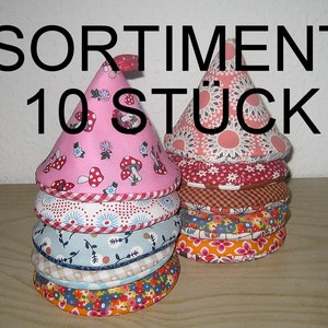 Könnte beinhalten: Ein Stapel aus 10 bunten Stoffkegeln mit verschiedenen floralen und geometrischen Mustern. Der Text "SORTIMENT 10 STÜCK" ist auf dem Bild zu sehen.