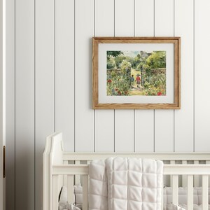 May include: A framed watercolor painting of two children walking through a garden gate. The painting is in a light wood frame and is hanging on a white wall.