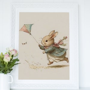 May include: A watercolor illustration of a brown rabbit wearing a blue dress and a pink bow, running with a pink and blue kite in a beige background.