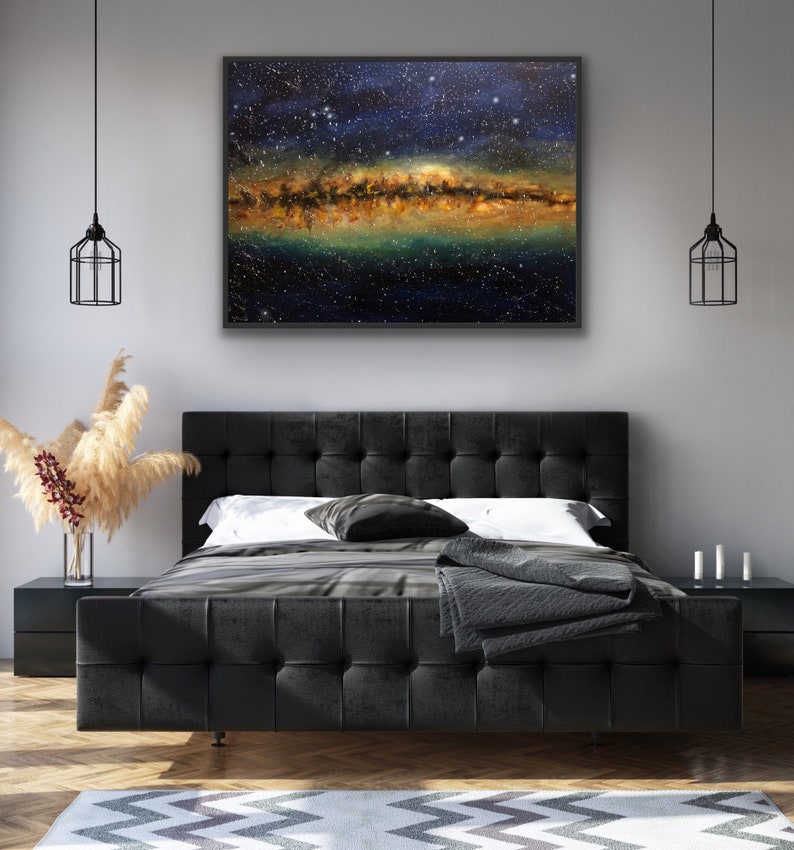 May include: A black tufted headboard bed with a white duvet and a black throw blanket. A framed painting of a starry night sky with a galaxy of stars hangs above the bed.