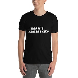 May include: Black t-shirt with white text that reads "max's kansas city"