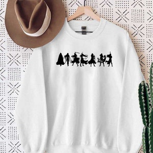 May include: White sweatshirt with a black silhouette of a group of people in various poses. The silhouette is centered on the sweatshirt.