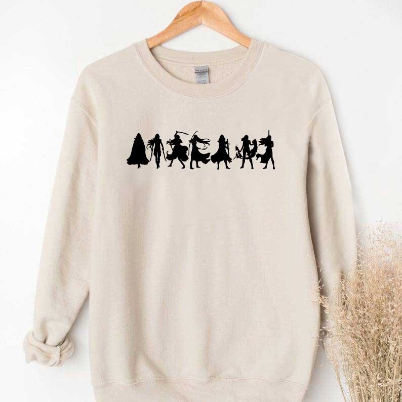 May include: A beige sweatshirt with a black silhouette of a group of people in various poses. The silhouettes are in a line across the front of the sweatshirt.