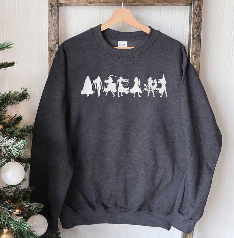 May include: A dark gray sweatshirt with a white graphic of a group of figures in silhouette. The figures are arranged in a line and appear to be wearing different costumes.