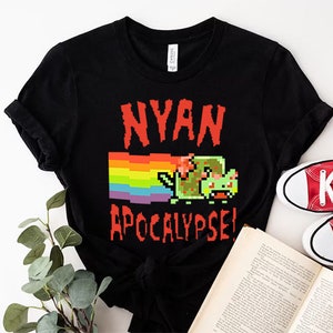 May include: Black t-shirt with a rainbow and a pixelated cat with the text "NYAN APOCALYPSE!"