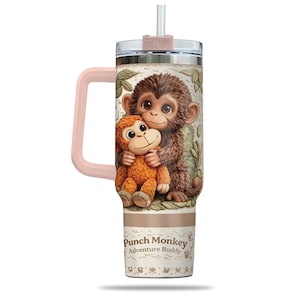 May include: A white ceramic mug with a black handle and the text "But First, Coffee" in a bold, black font. The mug is set against a blurred background, suggesting a cosy setting.