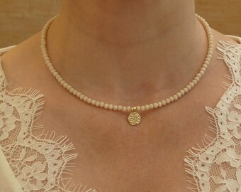 Light Pink Necklace Made From 4mm Faceted Glass Beads, Featuring a Lovely Round Gold Plated Pendant with a Star Design in Zircon Diamonds.