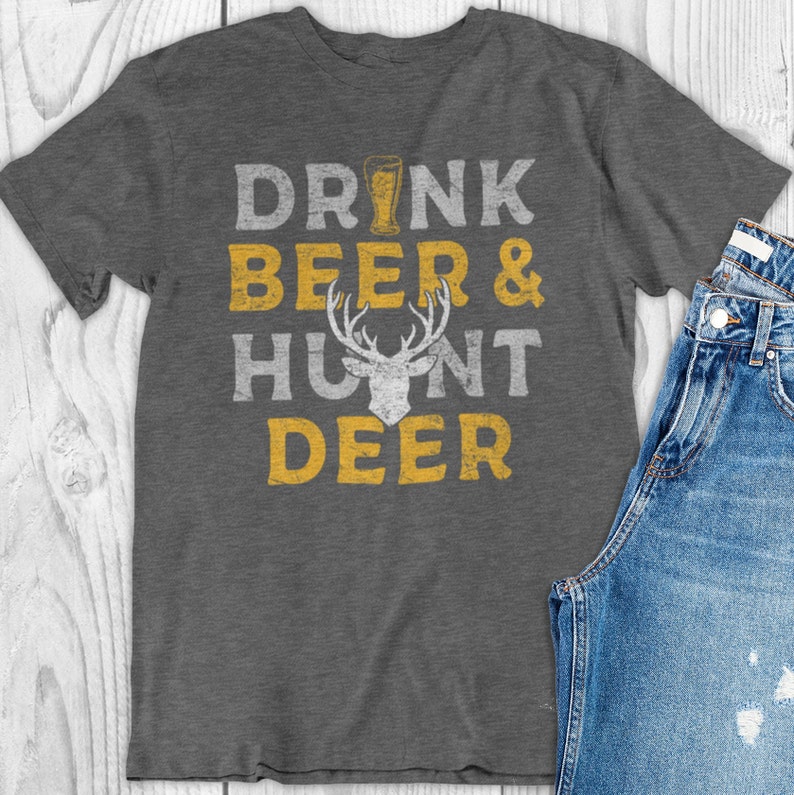 May include: A gray t-shirt with the text "Drink Beer & Hunt Deer" in yellow with a deer silhouette in the middle.
