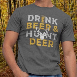 May include: A gray t-shirt with the text "DRINK BEER & HUNT DEER" in yellow with a white deer silhouette in the middle.