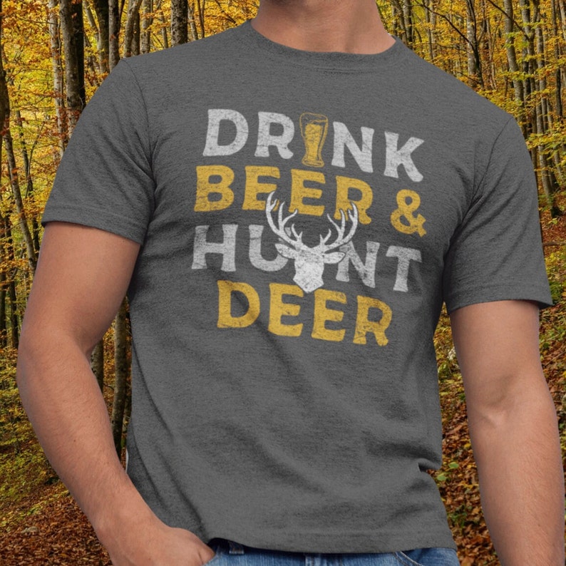 May include: A gray t-shirt with the text "DRINK BEER & HUNT DEER" in yellow with a white deer silhouette in the middle.