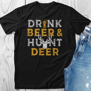 May include: Black t-shirt with a distressed yellow graphic that says "Drink Beer & Hunt Deer" with a stylized deer head in the middle.