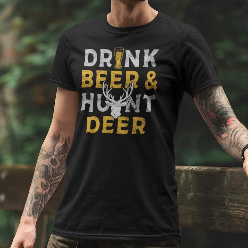 May include: Black t-shirt with a yellow graphic that says "Drink Beer & Hunt Deer" with a beer glass and a deer head.
