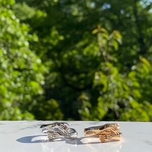 Hands hugging ring set