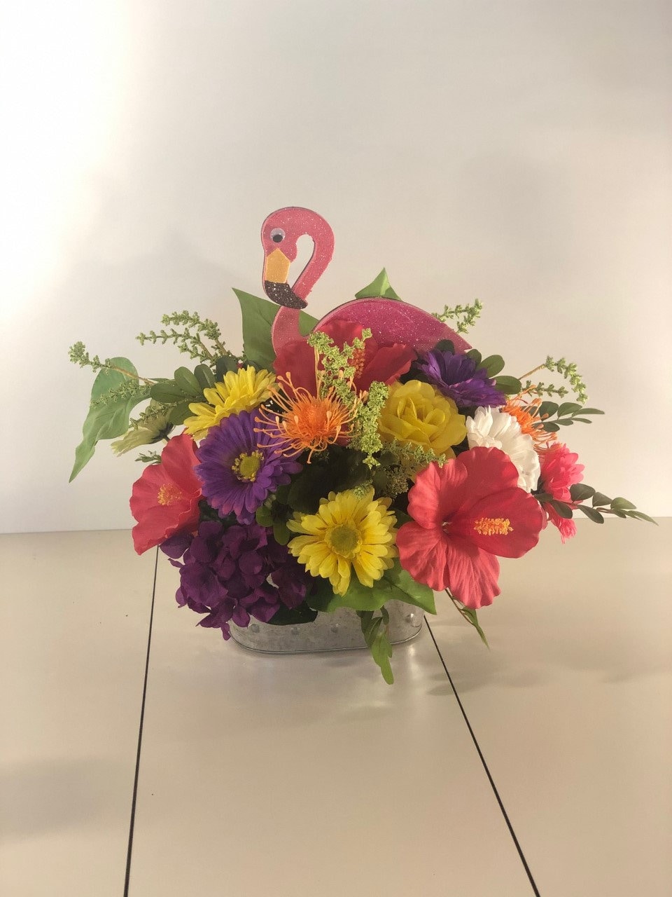 Flamingo centerpiece with hibiscus Tropical centerpiece in galvanized bucket with hibiscus