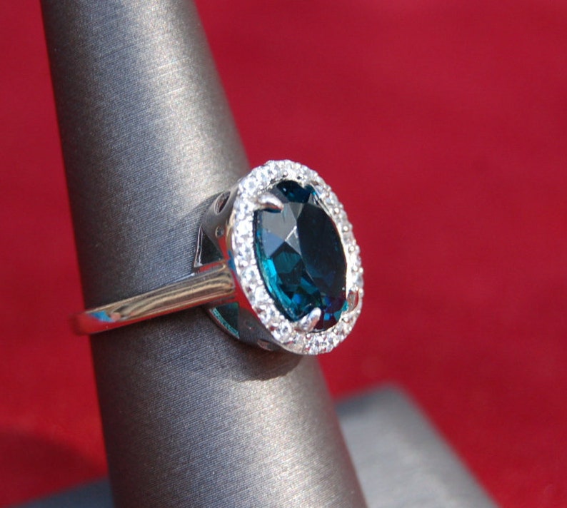 Oval London Blue Topaz Ring surrounded by Crystals Ring Size 7.