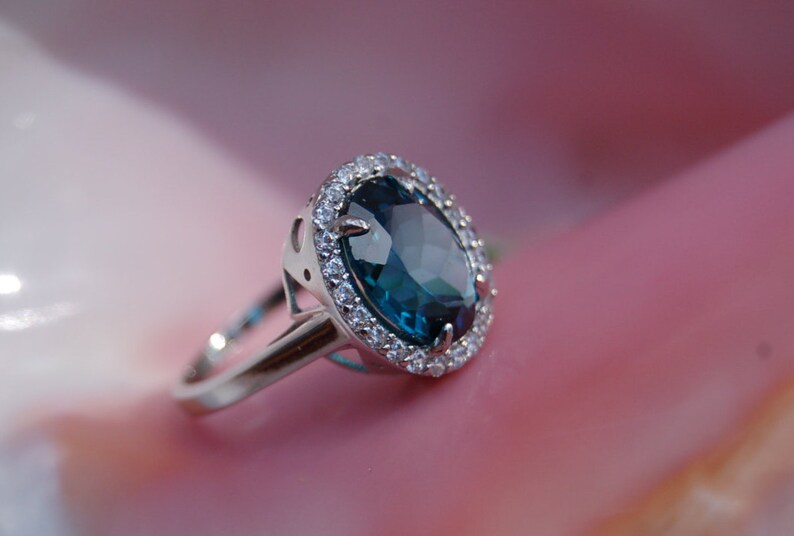 Oval London Blue Topaz Ring surrounded by Crystals Ring Size 7.