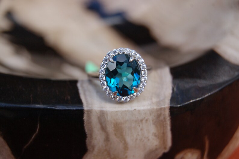 Oval London Blue Topaz Ring surrounded by Crystals Ring Size 7.