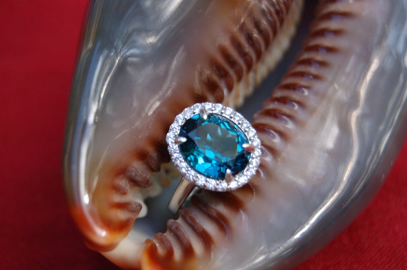 Oval London Blue Topaz Ring surrounded by Crystals Ring Size 7.