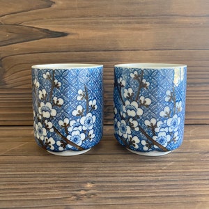 vintage Japanese stoneware tea cups with blue and brown cherry blossom design set of 2