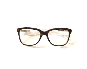 May include: Tortoise shell eyeglasses with clear lenses and a white frame.