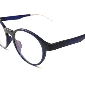 May include: A pair of round, blue-framed eyeglasses with clear lenses. The frames have a subtle gradient effect.