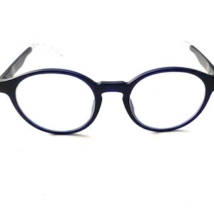 May include: A pair of round, blue-framed eyeglasses with clear lenses.
