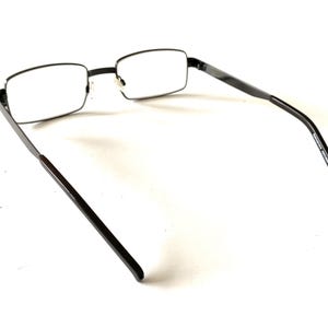 May include: Black rectangular eyeglasses with clear lenses. The frames are a dark, matte finish, and the temples have a slight curve. The glasses are set against a white background.
