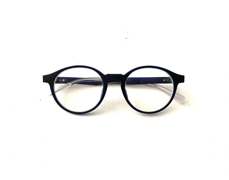 May include: Black round-framed eyeglasses with clear lenses.