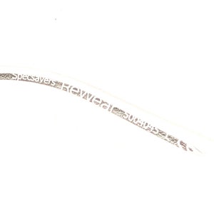 May include: Close-up of a white cable with the text "Specsavers Rewear 5004032347" printed on it.