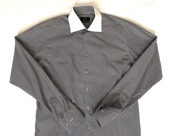 May include: A long-sleeved, striped dress shirt with a white collar. The shirt has a button-up front and a slim fit.