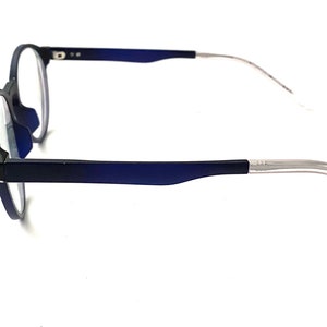 May include: Blue and silver eyeglasses with round lenses and a thin metal frame.