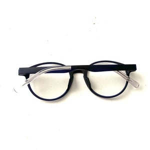 May include: A pair of blue-framed eyeglasses with clear lenses. The glasses have a simple, modern design.
