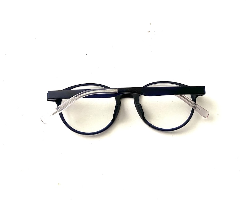 May include: A pair of blue-framed eyeglasses with clear lenses. The glasses have a simple, modern design.