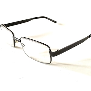 May include: Rectangular eyeglasses with a dark gray metal frame. The lenses are clear, and the arms of the glasses are straight and extend back from the frame. The glasses are set against a white background.