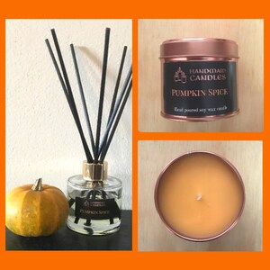 May include: A selection of autumnal home fragrance items. A glass diffuser with black reeds, a small pumpkin, and a copper-coloured tin candle labelled "Pumpkin Spice" are shown. The candle is hand-poured soy wax.