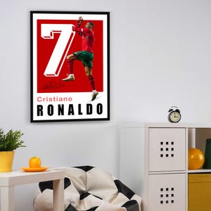 May include: A red and white poster with a photo of Cristiano Ronaldo in a soccer uniform, celebrating a goal. The poster has the number "7" in large white letters and the text "Cristiano RONALDO" in black letters.