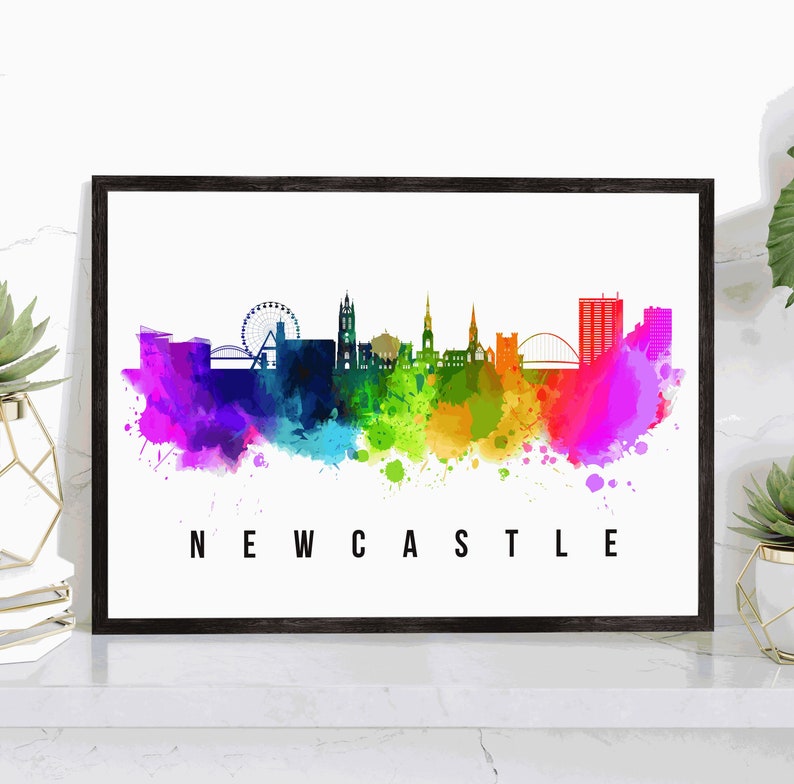 May include: A watercolor painting of the Newcastle skyline with a rainbow color scheme. The skyline includes the Tyne Bridge, the Millennium Bridge, and the iconic Sage Gateshead. The text "NEWCASTLE" is printed below the skyline.