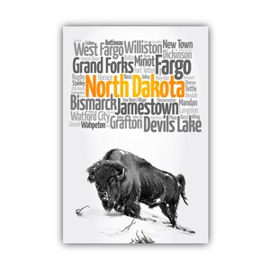 May include: A black and white word cloud of cities in North Dakota with a black and white image of a buffalo in the bottom right corner. The word "North Dakota" is highlighted in orange.