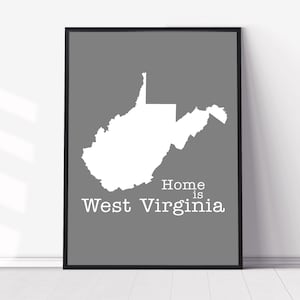 May include: A gray and white print with the outline of the state of West Virginia. The text "Home is West Virginia" is printed below the state outline.