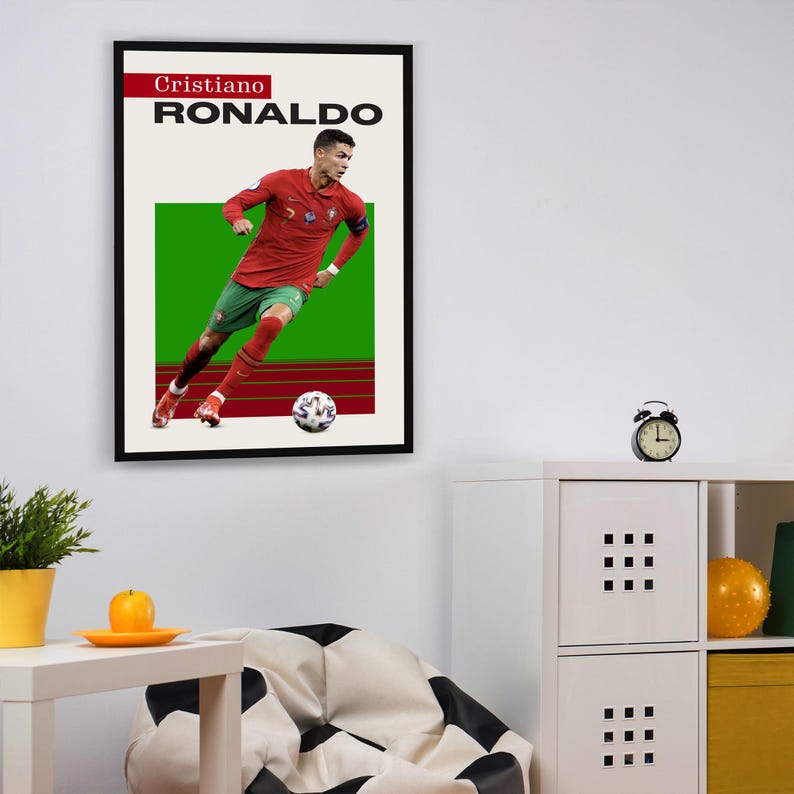 May include: A framed poster featuring a soccer player in a red and green jersey, dribbling a soccer ball. The poster has the text "Cristiano RONALDO" at the top.