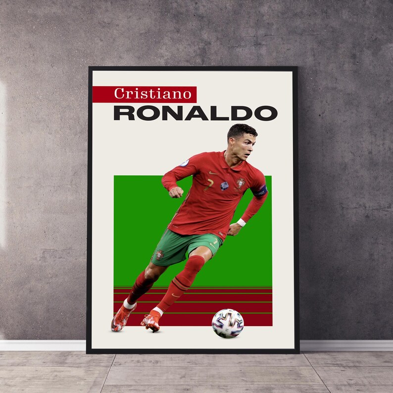 May include: A poster featuring Cristiano Ronaldo in a red and green soccer uniform, dribbling a soccer ball on a green field. The poster has the text "Cristiano RONALDO" in black and red.
