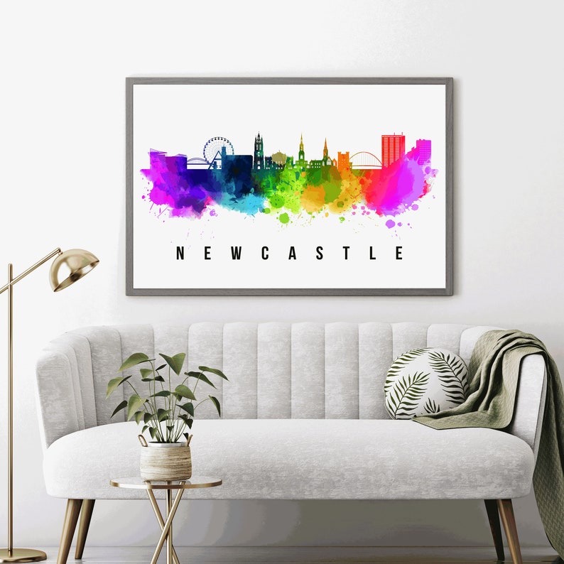 May include: A watercolor painting of the Newcastle skyline in rainbow colors. The city's iconic landmarks are visible, including the Tyne Bridge and the Millennium Bridge. The word "NEWCASTLE" is written in black letters below the skyline.