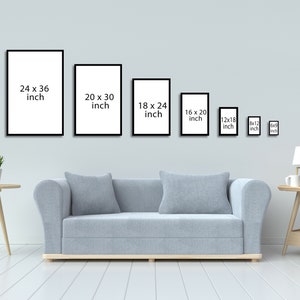 May include: A white wall with a row of black picture frames of different sizes. The frames are empty and have the dimensions listed in inches. A light gray sofa sits in front of the wall. A small table with a lamp and a cup sits on the right side of the image.