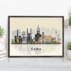 May include: A black and white illustration of the Como, Italy skyline with a reflection of the city below. The text "Como" is written in black below the reflection.