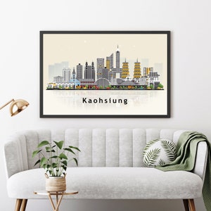 May include: A black framed print of a skyline of Kaohsiung, Taiwan. The skyline is depicted in a minimalist style with gray, black, and white buildings. The print has a beige background and the city name is written in black at the bottom.
