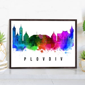 May include: A watercolor illustration of the Plovdiv skyline with colorful splashes of paint. The city's buildings are outlined in black and the city name is written in black at the bottom of the image.