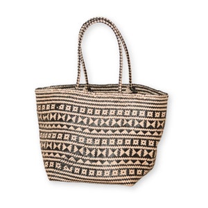 May include: A black and beige woven tote bag with a geometric pattern. The bag has two handles.