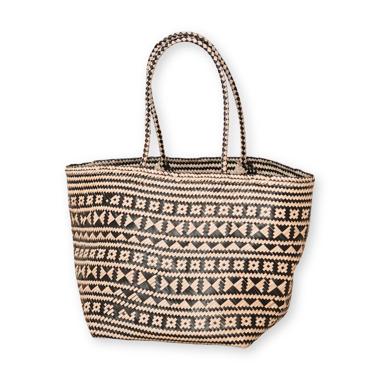 May include: A black and beige woven tote bag with a geometric pattern. The bag has two handles.